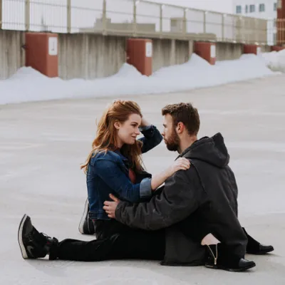 couple sitting straddling each other outside having a serious conversation about erectile dysfunction