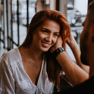 man touching woman't face as a way to initiate sex